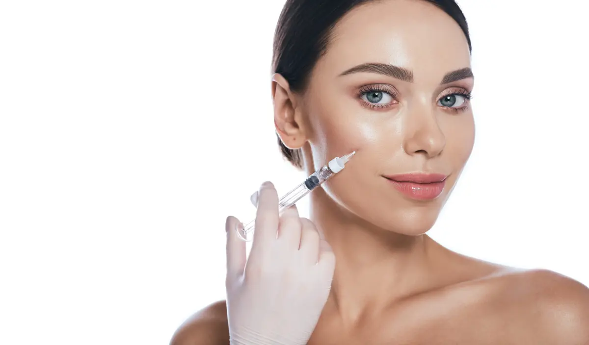 Close-up of a woman receiving a dermal filler injection in her cheek to restore facial volume at Natural Results Medical Aesthetics.